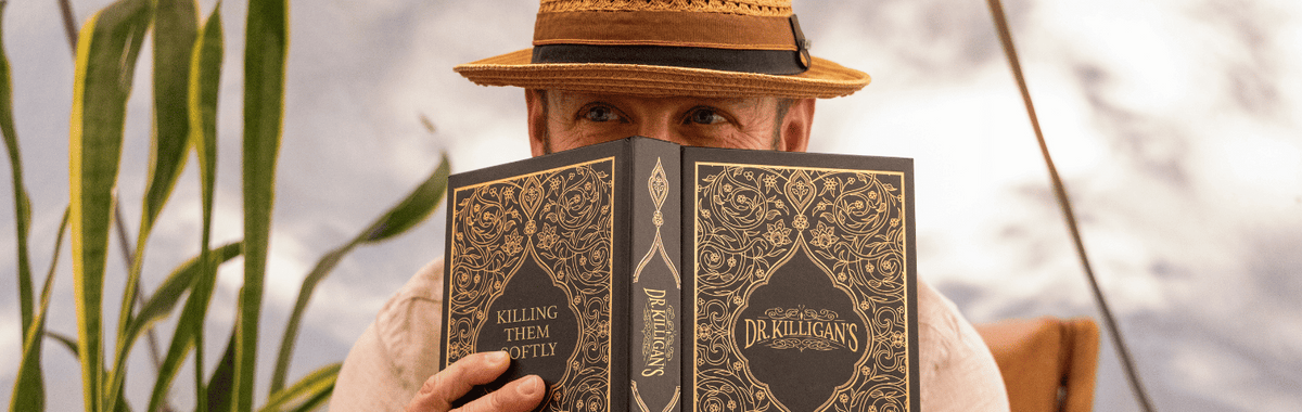 Man in a hat reading the book Killing Them Softly