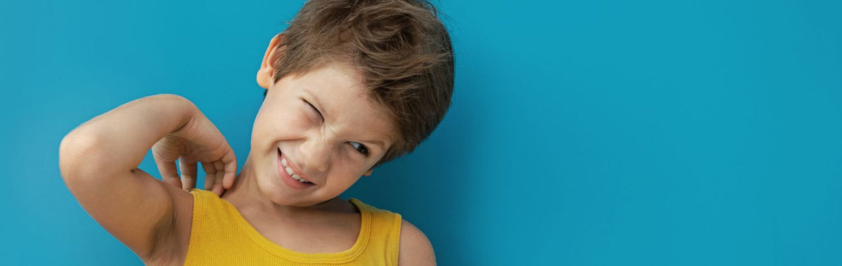 Child scratching an itchy shoulder from flea bites