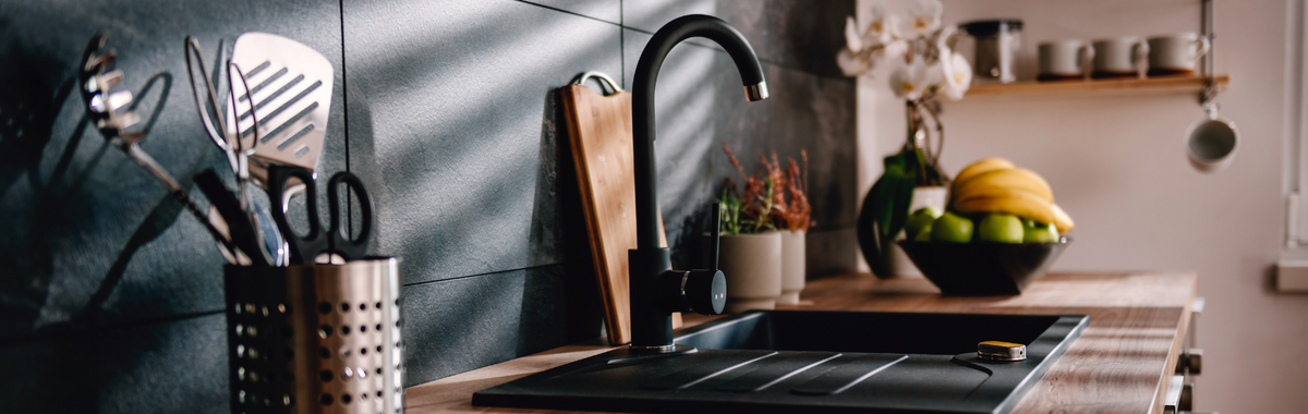 Modern kitchen with a black sink and countertop