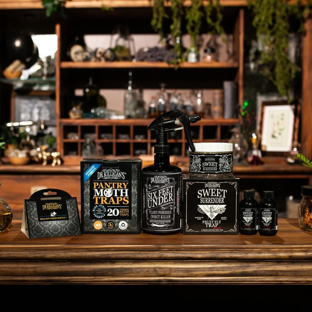 Dr. Killigan's pantry moth traps, fruit fly traps and Six Feet Under plant-powered insect killer on a wooden shelf. #size_medium