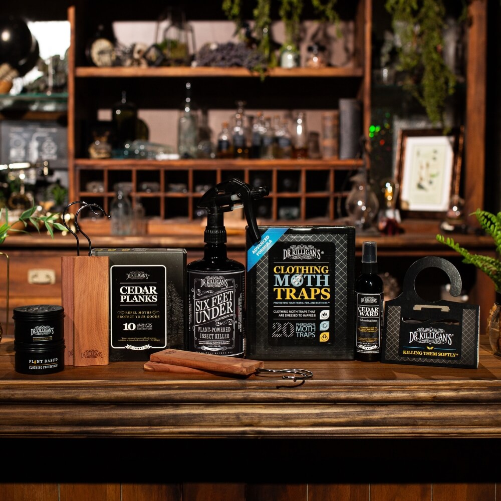 Collection Dr. Killigan's clothing moth products on a wooden surface with a blurred background. #size_large