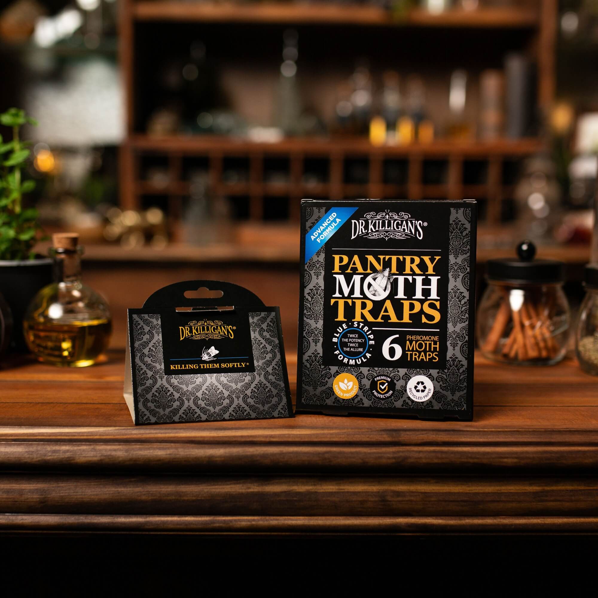 Dr. Killigan's Pantry Moth Traps packaging on a wooden shelf with a blurred background