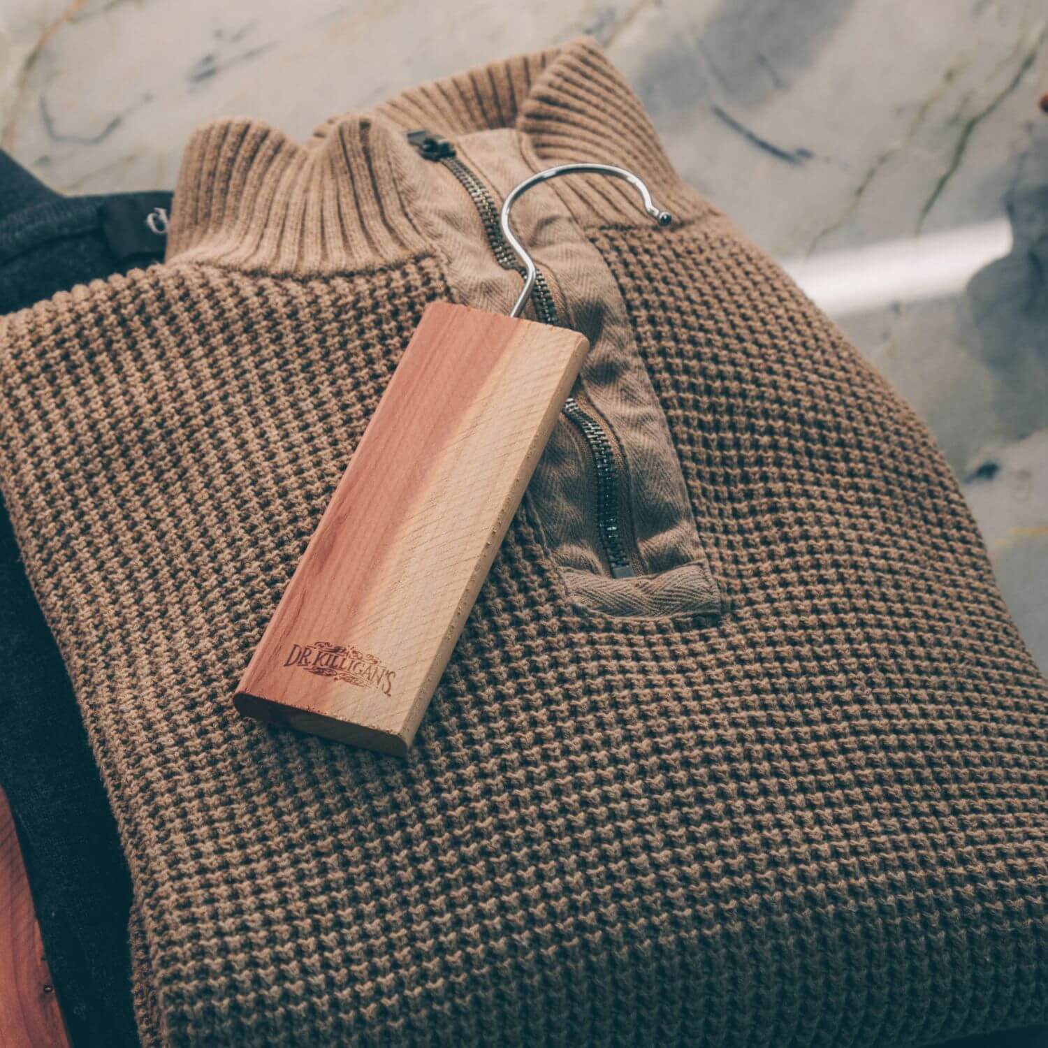 Dr. Killigan's Cedar Plank resting on brown sweater.